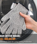 Fiberglass Free Level 5 Cut Resistant Gloves being shown in grey color, held in hand, beside washing machine