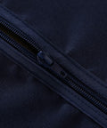 Close-up of a zipper on Outdoor Table Cover With Umbrella Hole And Zipper 60x84 Inch Navy Low Maintenance Washable Waterproof Spill Proof Wrinkle Free