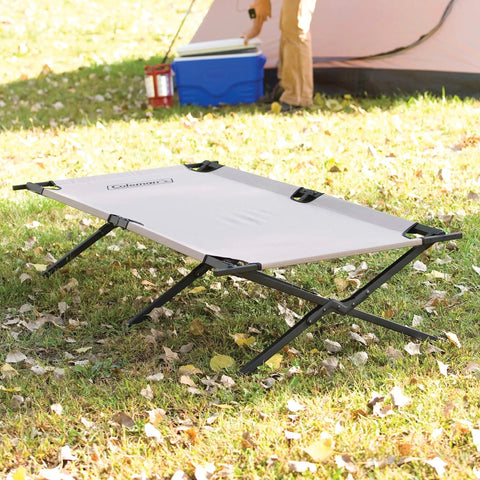 Trailhead II Large Folding Camping Cot with steel frame on grass near a tent, supports up to 300 lbs, stands 6 ft 2 in tall, portable