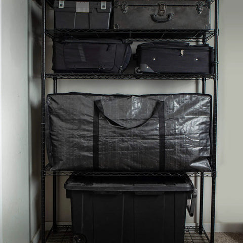 XXL 68.5 Gallon Heavy Duty Storage Bags Two Pack With Mega Strong Wrap Around Handles on shelf, folded and reusable.