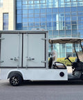 Cruise Around In Style With This Nimble 2 Seater Electric Golf Cart Rolling A Spacious Cargo Bed For Yard Work And Neighborhood Cruises Packed With A Smooth Brushless Motor, side view in a urban setting.