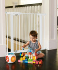 Child playing near 11 Inch White Baby Gate Extension For Easy Close Metal, Auto Close Metal, Safe Step With Trip Guard, It Fits And Click Lock Gates