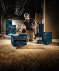 Man organizing tools in L BOXX 2 Stackable Tool Storage Case With One Click Stacking in workshop setting
