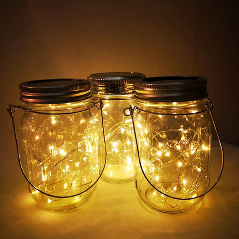 Lit Solar Mason Jar Lights 4 Pack With 30 LEDs Starry Fairy String Hanging Jar Lights glowing indoors
