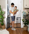 Walk Through Baby And Pet Gate Easy To Use For Doorways And Stairways No Drill Pressure Mount Adjustable, man holding baby near gate