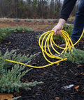 All Purpose Outdoor Extension Cord With A Lit End 50 Feet 12 Gauge 3 Prong SJTW Yellow Weatherproof Vinyl Jacket in use outdoors
