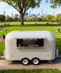 Kickstart Your Food Truck Trailer And Hot Dog Cart Venture With Commercial Mobile Kitchen Rig For Coffee Shop And Ice Cream Stand Business Hustle Dope Full Setup in a park, featuring a portable stainless food trailer.