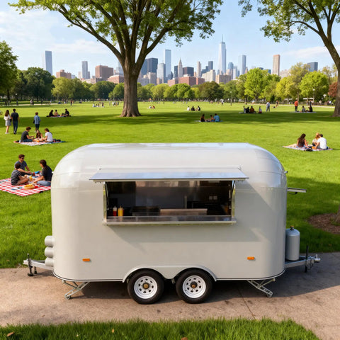 Kickstart Your Food Truck Trailer And Hot Dog Cart Venture With Commercial Mobile Kitchen Rig For Coffee Shop And Ice Cream Stand Business Hustle Dope Full Setup in a park, featuring a portable stainless food trailer.