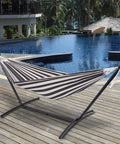 Outdoor Double Hammock With Sturdy Steel Stand Heavy Duty Frame Holds Up To 450 Lb by a poolside on a wooden deck