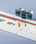 Solderless Prototype Breadboard Kit with 1x830 tie in grid showing mounted components and jumper wires for DIY prototyping
