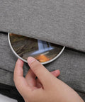 Hand placing 10W Fast Wireless Charger Pad Ultra Slim Portable Charging Station into grey fabric bag pocket