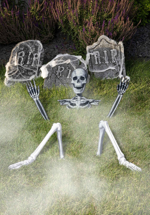 5 Piece Skeleton Ground Breaker Yard Prop Set For Halloween Decorations among tombstones on grass