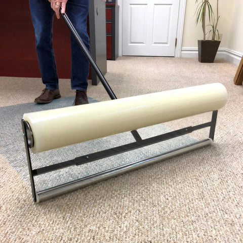 Applying Carpet Protection Film 24 Inch By 50 Foot Self Adhesive Floor Shield Rug Guard with roller on beige carpet