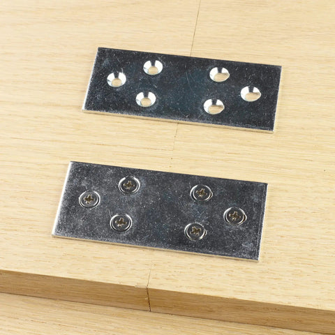 Heavy Duty Galvanized Mending Plates 3.5 By 1.5 Inches Steel braces mounted on wood surface for panel repair.