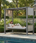 Woman relaxing on 2 In 1 Convertible Porch Swing Bed For Three With Wicker Armrests And Adjustable Canopy by the poolside