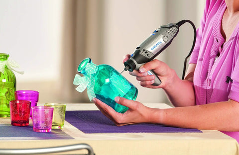 Person using Diamond Wheel Point Accessory Set Two Pack With 2.0mm Engraving Bits for engraving on a glass vase