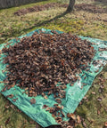Drawstring 9x9 Tarp For Leaves And Outdoor Use With Cinch Bag Easy Cleanup Heavy Duty Cover Tarp spread on grass with leaves
