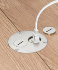 Flush Round Floor Box Kit For Wood Or Concrete Floors with nickel plated cover, power cord in plug, two threaded inserts visible.