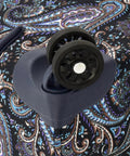 Close-up of wheel and paisley design on Mayfair 4 Piece Softside Luggage Set With USB Port Navy White Paisley 20 Inch Carry-On