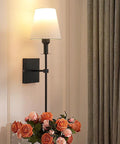 Two Pack Battery Operated Wall Sconces With Remote Control, Dimmable Brightness From 10 to 100 Percent And Color Temperature From 2700K to 6500K, USB Charging Cable Included, Bulb Included, Easy Install, Black Finish, Wireless Non Hardwired Lighting next to flowers