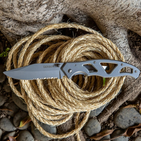 Paraframe II Go-To EDC Folding Pocket Knife with 3.5 inch serrated blade and safety frame lock on coiled rope outdoors.