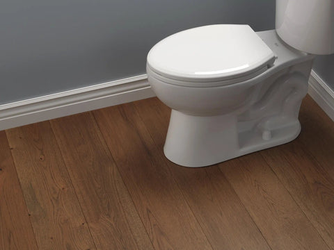 Sanborne Elongated Slow Close Toilet Seat With No Slip Bumpers installed on white toilet in bathroom with wood floor