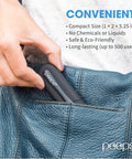 Peeps eyeglass lens cleaner, compact black carbon microfiber device with white Peeps logo in a denim pocket