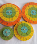 Three Dimensional Periodic Table Display With Eight Hardwood Disks Featuring Element Symbols And Atomic Numbers on table
