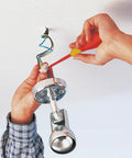 Hands using Insulated SoftFinish 7 Piece Screwdriver Set Pro Grade VDE Tested Up To 1000V on ceiling light installation.