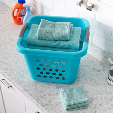 Deep 30L Laundry Basket Hamper Organizer With Built In Comfort Carry Handles So Handy Ventilated Nestable Design 2 Pack Medium Teal on countertop with folded towels