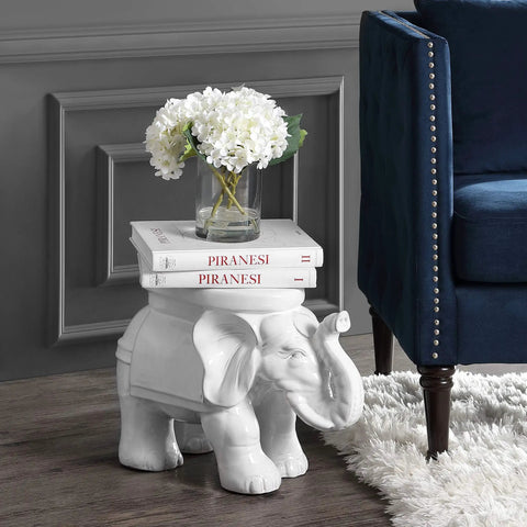 White Elephant Ceramic Garden Stool 14.25 Inch Glazed Elephant Seat with books and flowers in a living room setting