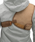 Adjustable rifle and shotgun shoulder shield with leather recoil pad for hunting and archery, brown suede, rear view