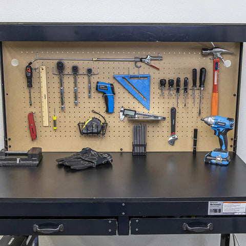 100 Piece Metal Pegboard Hooks And Accessories Set For One Eighth And One Quarter Inch Peg Boards organizing tools on a black workbench.