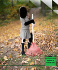 Child using a red kids rake with hardwood handle in a yard with autumn leaves