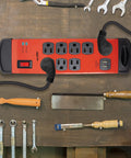 Heavy Duty 15 Foot 8 Outlet Metal Surge Protector Power Strip With 2 USB Ports, 1960 Joules, Flat Plug, Red on workbench