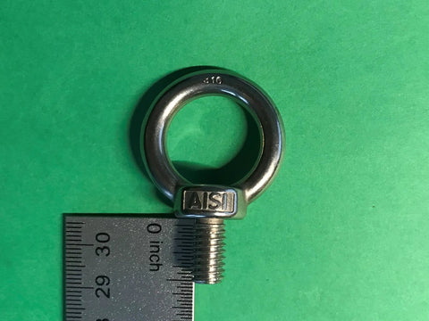 Close-up of a Set Of Four Beefy Marine Grade Stainless Steel Lifting Eye Bolts Five Sixteenth Inch UNC AISI 316 on a green background.