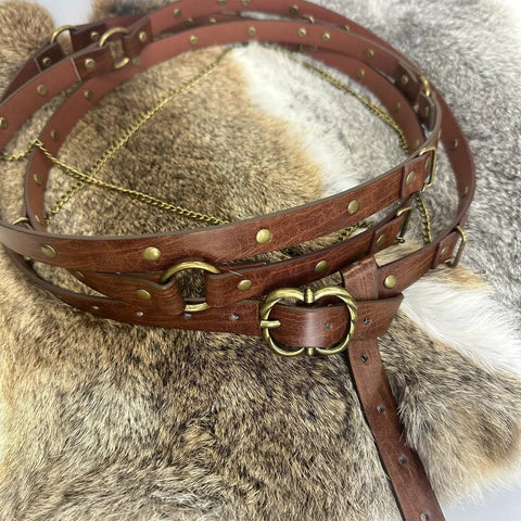 Snag This Fresh Medieval Faux Leather Wrap Belt To Kick Up Your Vintage Look With Adjustable Chain Details And A Snug Custom Fit That Elevates Your Everyday Streetwear Game Instantly on a textured fur background.