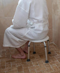 Person using Aluminum Bath And Shower Chair With Adjustable Height And Anti Slip Medical Seat For Easy Safe Transfers 300 lb