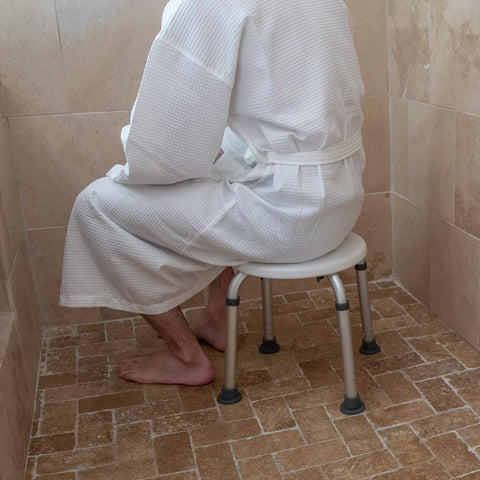 Person using Aluminum Bath And Shower Chair With Adjustable Height And Anti Slip Medical Seat For Easy Safe Transfers 300 lb
