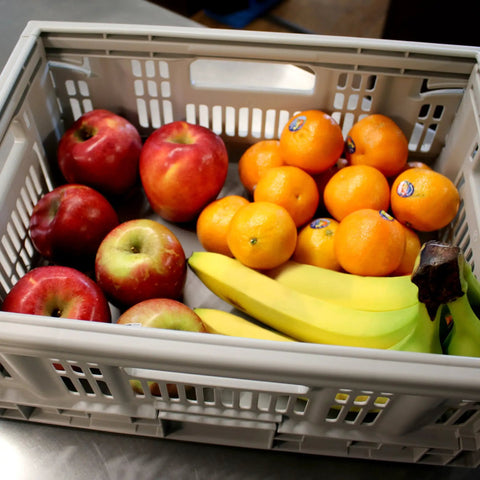 Must-Have Collapsible Utility Crates Set Of 3 Grey 15.8L filled with fruits like apples and oranges on a kitchen counter.