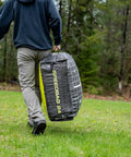 Person carrying Beast 24 Inch Dual Sided Archery Target For 475 FPS Compound Bows And Crossbows in wooded area
