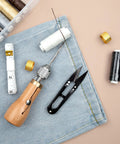 Handy Sewing Awl Kit For Leather Stitching, Portable All-In-One Tool Set with accessories on denim fabric background