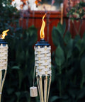 Easy Pour 12 Pack Bamboo Torch Set With Classic Weave Brown Finish Outdoor Lawn Patio Garden Lighting Weather Resistant 57 Inch Tall Decorative Torches Renewable Bamboo Spill Free Fuel Canisters