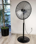 30 Inch Industrial Heavy Duty Pedestal Oscillating Metal Stand Fan With All Metal Construction Powder Coated Rust Resistant Finish And High Velocity Airflow For Indoor Or Outdoor Spaces Perfect For Garage Workshop Or Home Use in a room.