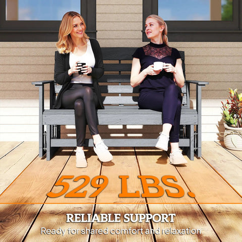 Two Person Outdoor Glider Bench For Backyards And Patios In Weather Resistant HDPE Distressed Gray with women sitting