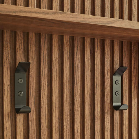 Mid Century Modern Fluted Walnut Wall Mount Coat Rack Panel with sturdy hooks against wood grain backdrop.