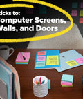 Desk setup with Ultra Sticky 3x3 Notes Pack, 15 Pads With 45 Sheets Each, Assorted Colors For Monitors, Walls And Windows, on wall and desk.