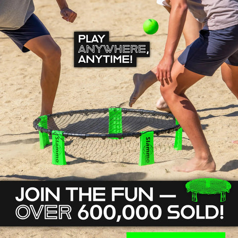 Roundnet Slammo Game Set For Backyard And Beach Fun being played on sandy beach with people engaged in a match.