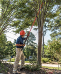 Man using 14 Foot Extendable Tree Pruner With RazorTOOTH DualCOMPOUND Action on tall tree branch outdoors