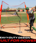 Man hitting baseball into 7 Ft X 7 Ft Baseball And Softball Practice Net With Bow Frame Carry Bag And Strike Zone
